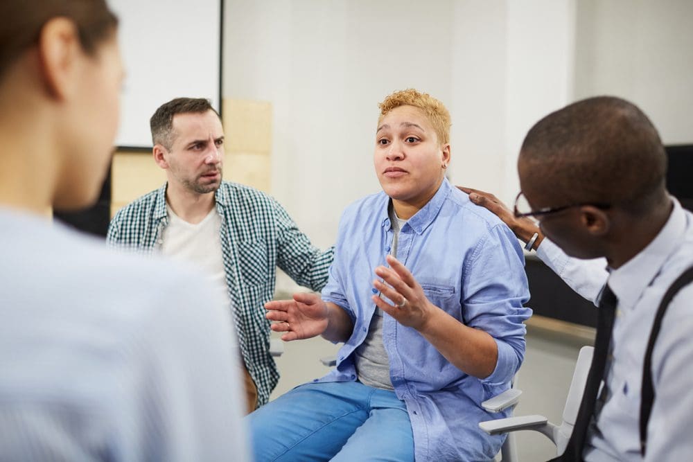 group therapy session where women talks